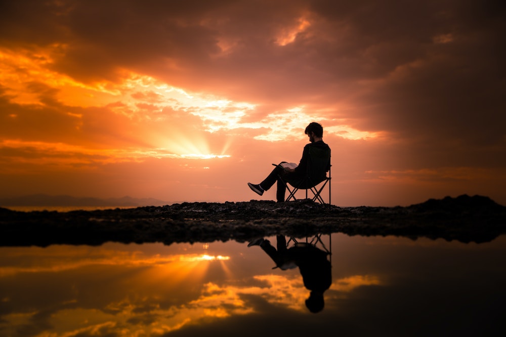 man-relaxing-beach-sunset-mindfulness