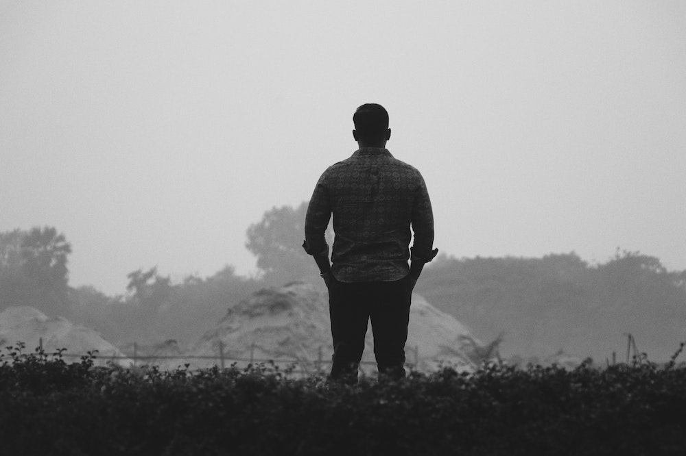 Man-standing-alone-childhood-trauma