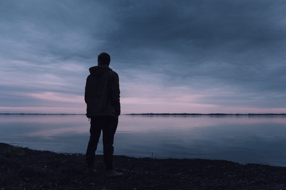 Person-Standing-Near-Lake