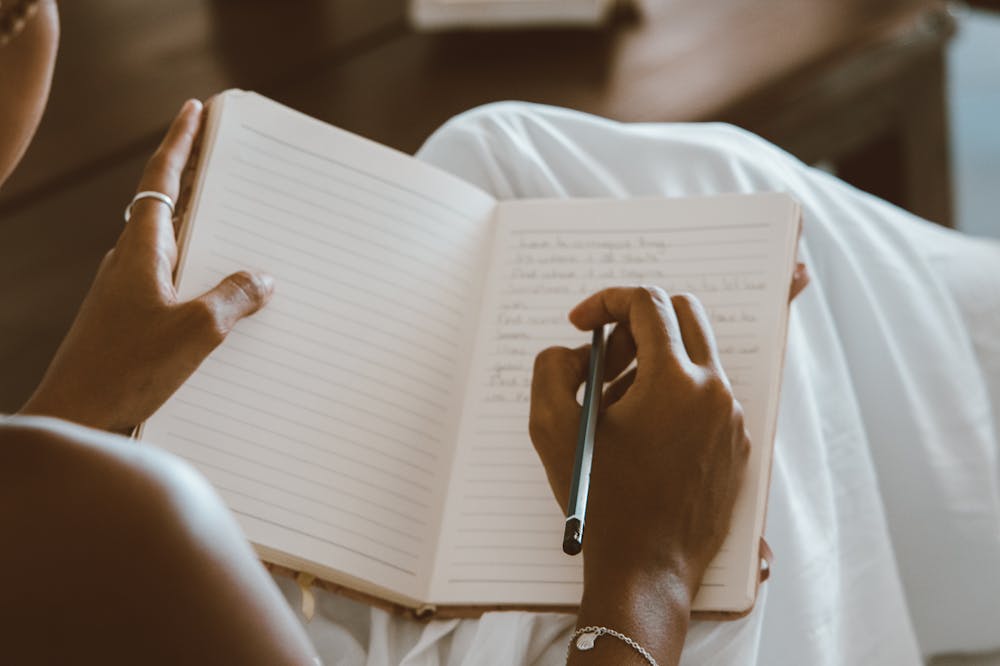 Person-writing-journal-regret