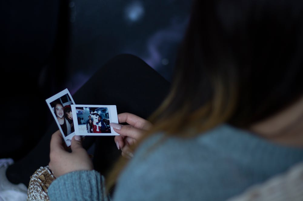 Woman-Holding-Two-Photos-Regret