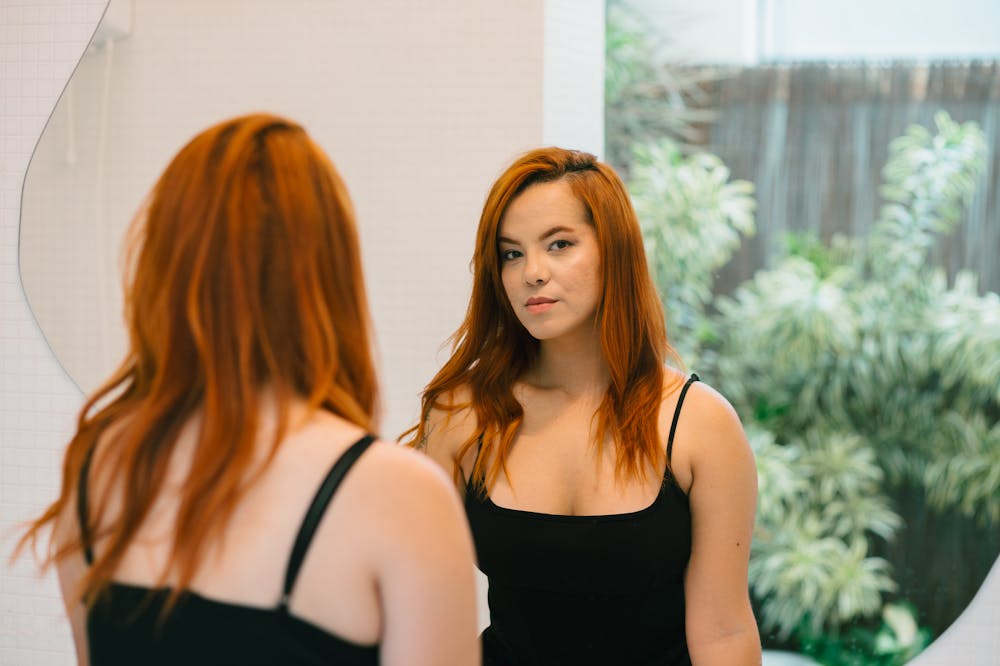 Woman-Smiling-at-Mirror-regret