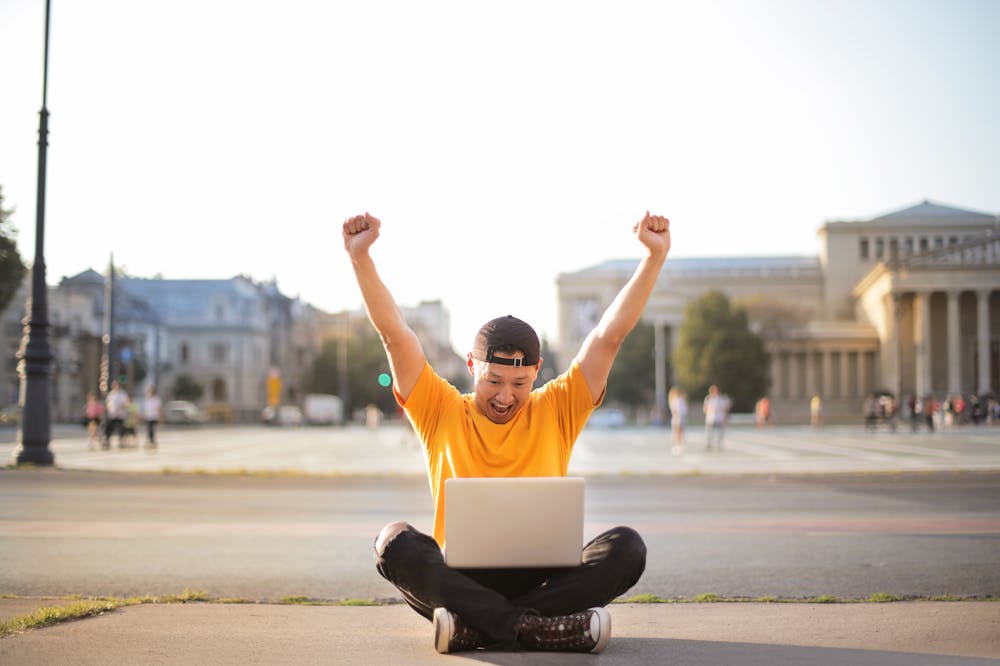 Ghosting-Person-Sitting-Sidewalk-Laptop