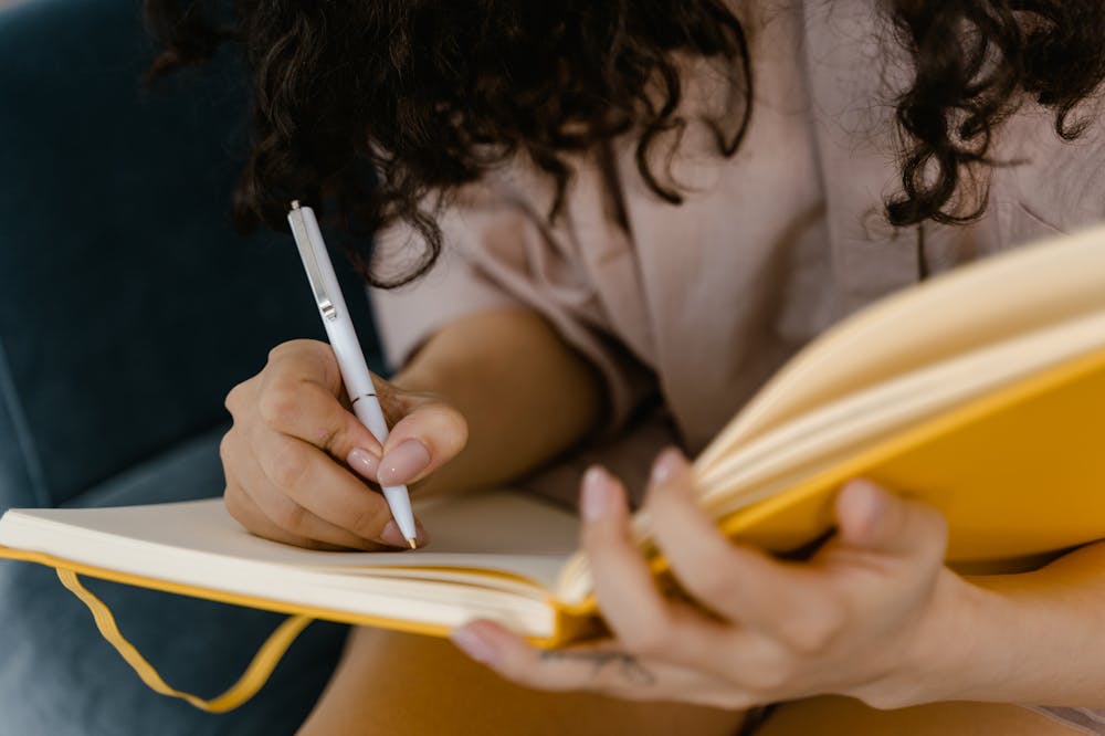 Ghosting-Person-Sitting-writing-journal