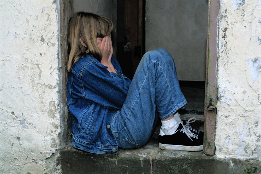 Lonely-Girl-sitting-on-Doorway