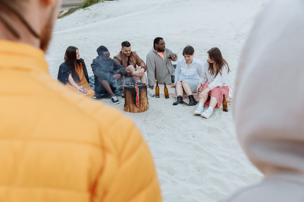 Group-Friends-Sitting-on-Sand