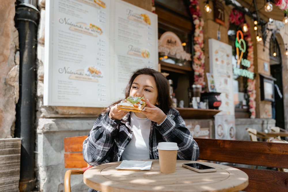 9 Ways Slow Living Can Lead To A Magical Sustainable Life 4 Woman-Eating-Sandwich-Slow-Living