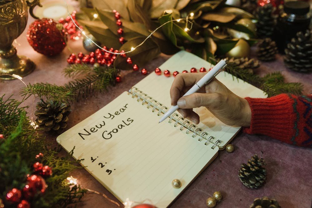 Person-Writing-Goals-In-Notepad