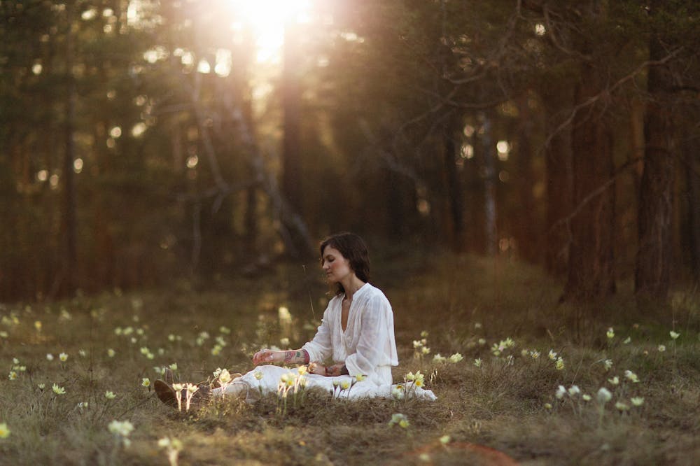 Woman-Sitting-on-Grass-Forest-bathing