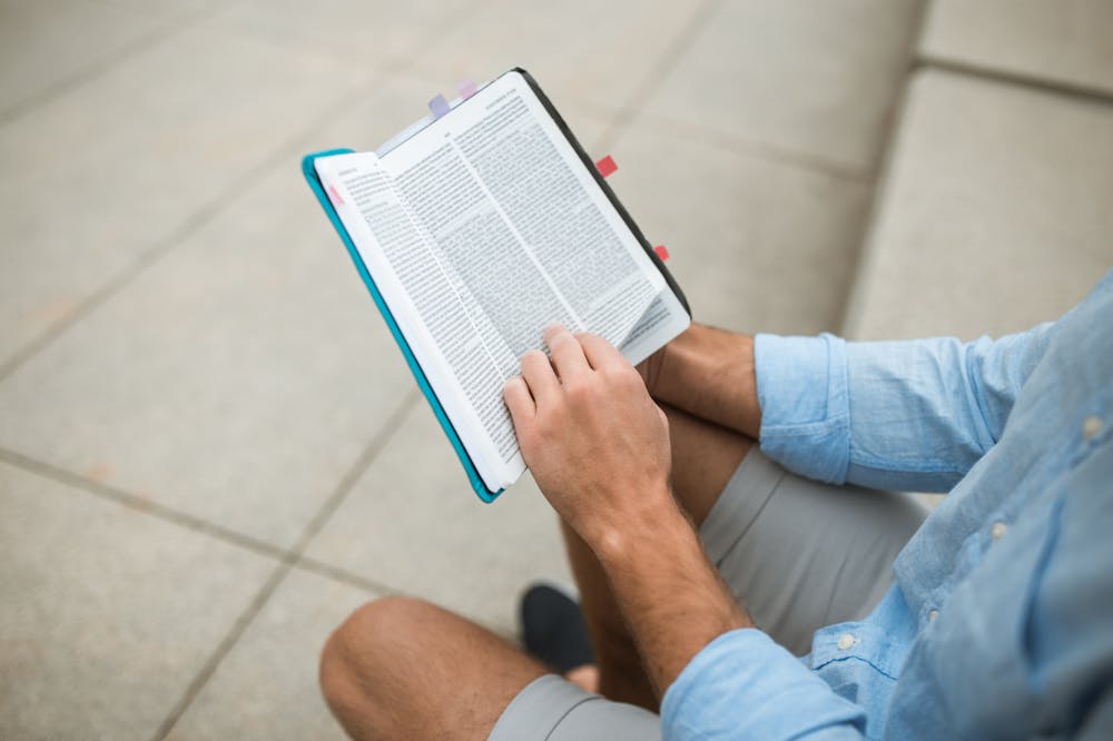 Man-In-Blue-Sleeves-Reading-Book