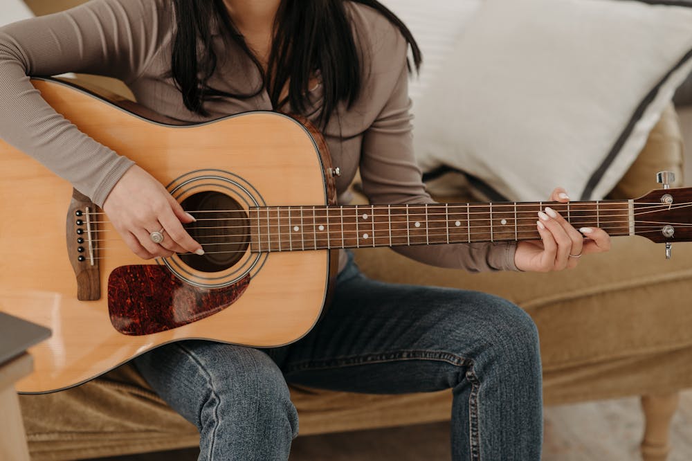 woman-practicing-acoustic-guitar
