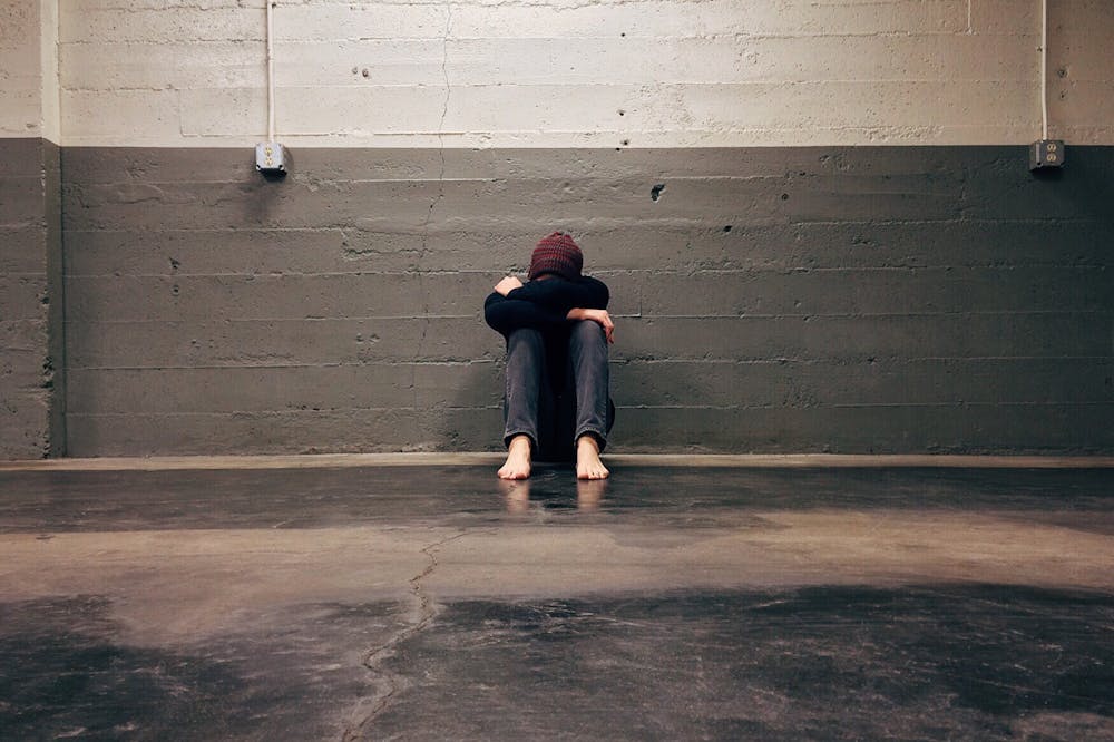 AI-Anxiety-Sad-Person-Leaning-on-Wall