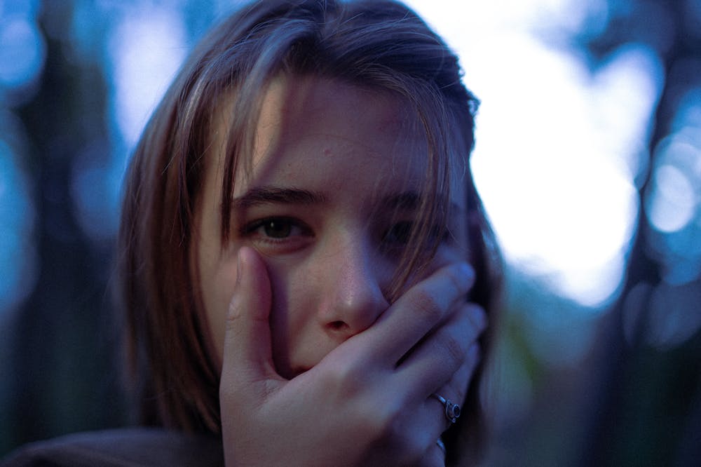 Close-Up-shot-Woman-Covering-Mouth
