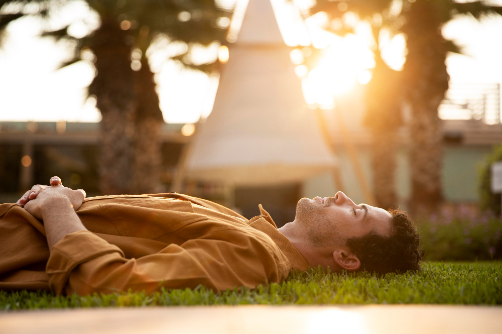 Feeling-stuck-man-laying-on-grass-eyes-closed