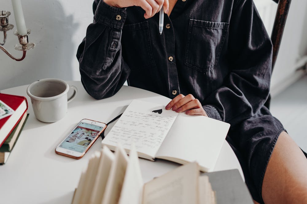 Man-Sitting-Down-Writing-Notes