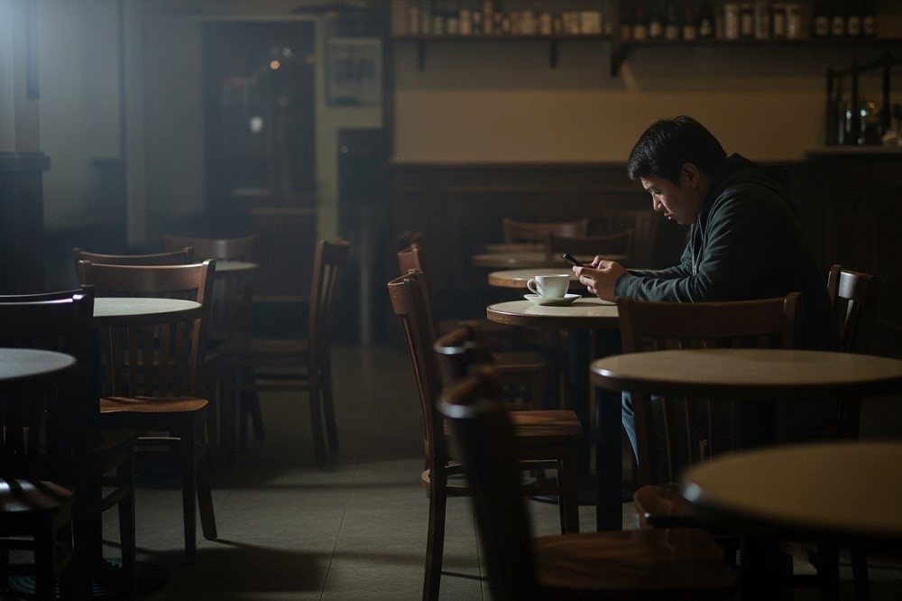 Outgrowing-People-Man-Sitting-Alone-In-a-Café