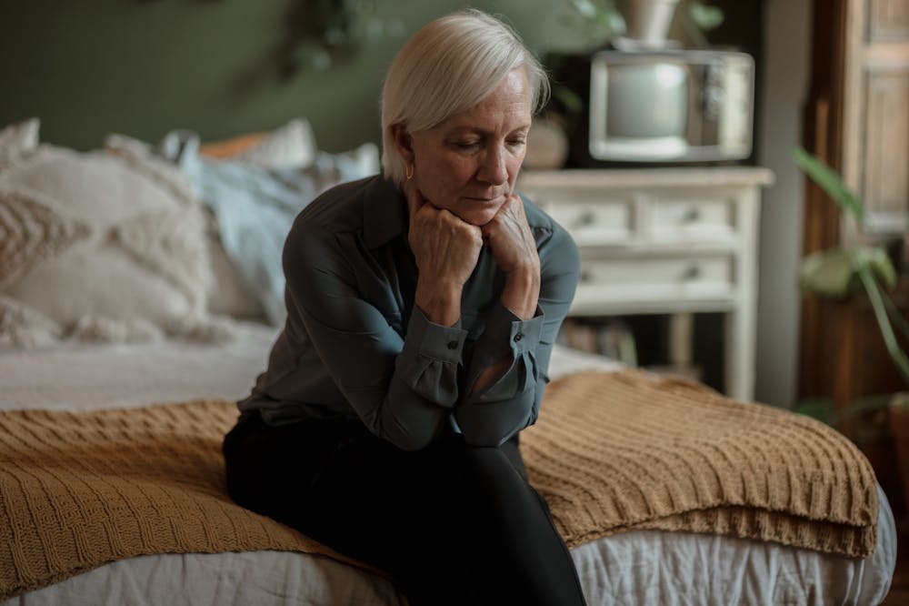 Sad-woman-sitting-on-bed