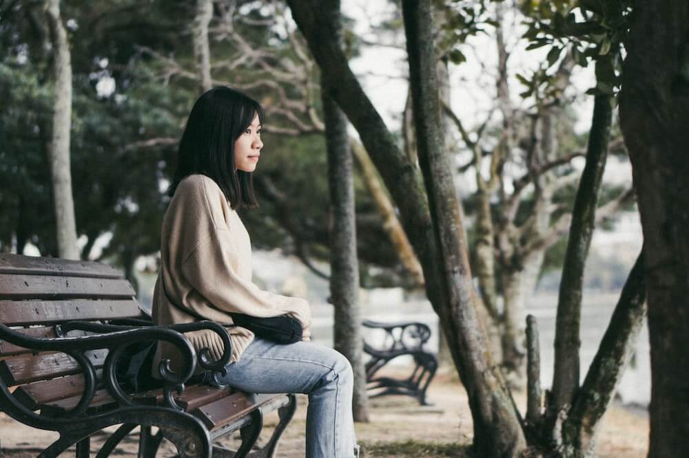 Woman-Sitting-on-Park-Bench