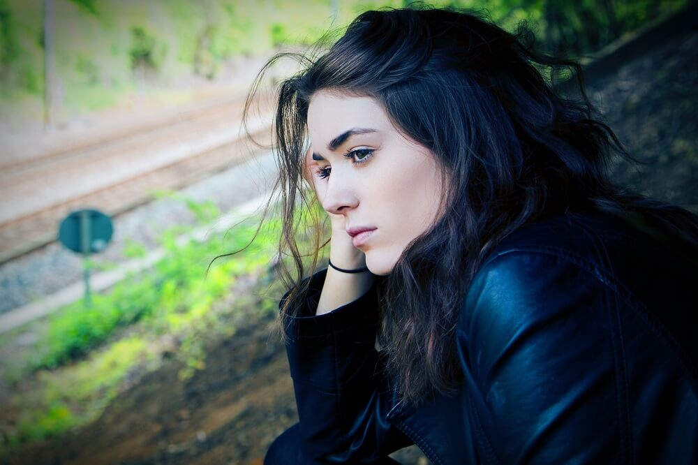 Woman-Looking-Outside-Window-Daydreaming