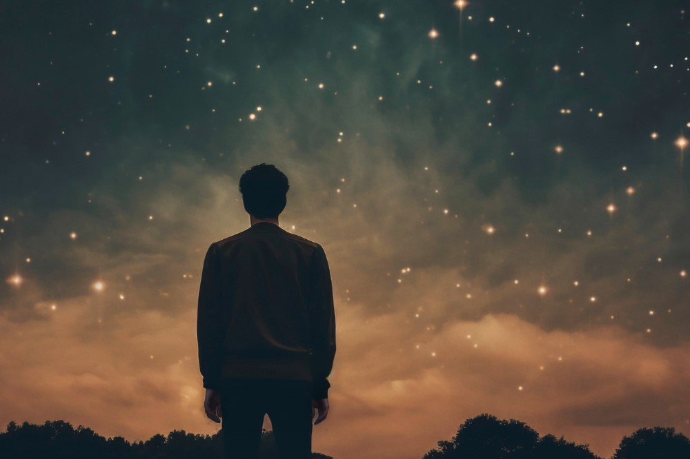 Man-Looking-At-Evening-Sky