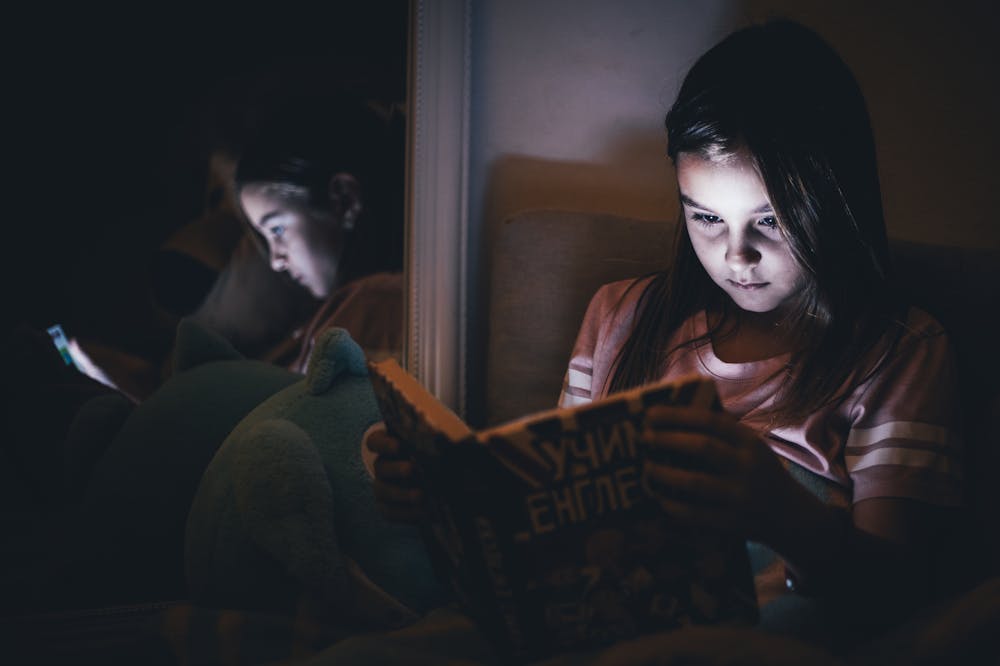 Girl-reading-book-phone-social-media-detox