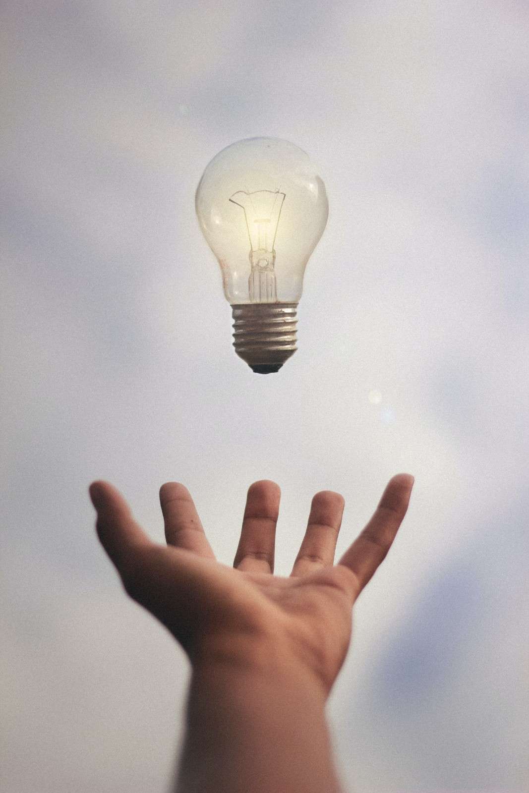Lightbulb-Suspended-above-outstretched-hand